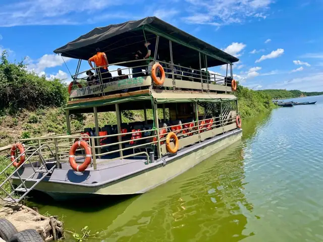 A double-deck safari boat on the water